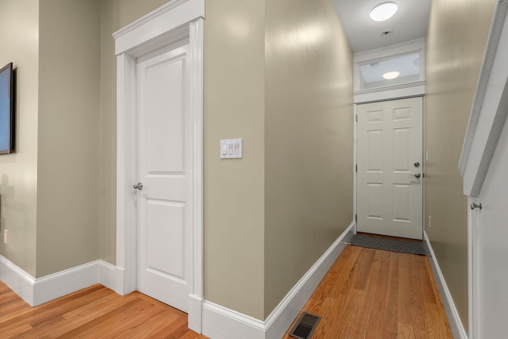 19 Pinckney Street, Unit 1 Somerville, MA 02145 - Photo 17 of 39 a view of a hallway with wooden floor
