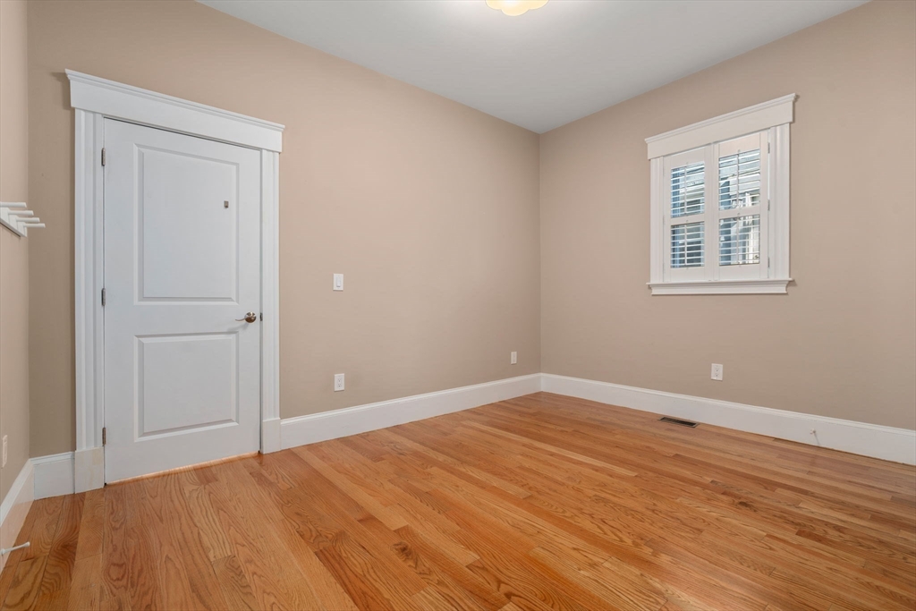 19 Pinckney Street, Unit 1 Somerville, MA 02145 - Photo 18 of 39 a view of an empty room with wooden floor
