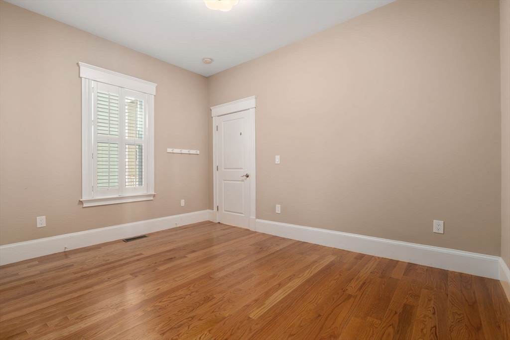 19 Pinckney Street, Unit 1 Somerville, MA 02145 - Photo 20 of 39 a view of an empty room with wooden floor and a window