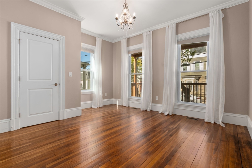 19 Pinckney Street, Unit 1 Somerville, MA 02145 - Photo 25 of 39 a view of an empty room with wooden floor and a window