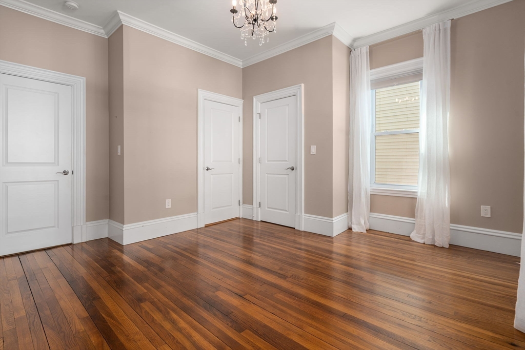 19 Pinckney Street, Unit 1 Somerville, MA 02145 - Photo 26 of 39 a view of an empty room with wooden floor and a window
