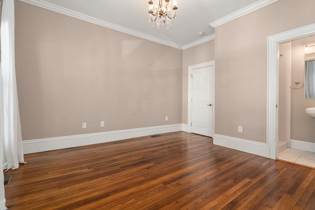 19 Pinckney Street, Unit 1 Somerville, MA 02145 - Photo 27 of 39 a view of an empty room with wooden floor