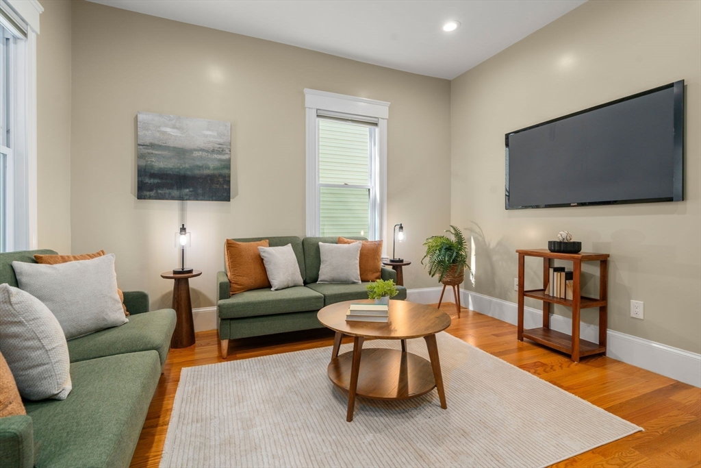 19 Pinckney Street, Unit 1 Somerville, MA 02145 - Photo 3 of 39 a living room with furniture and a flat screen tv