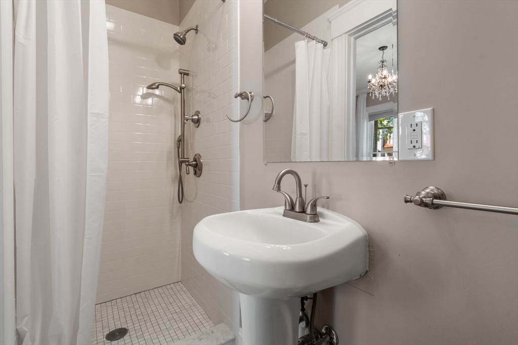 19 Pinckney Street, Unit 1 Somerville, MA 02145 - Photo 31 of 39 a bathroom with a sink and mirror