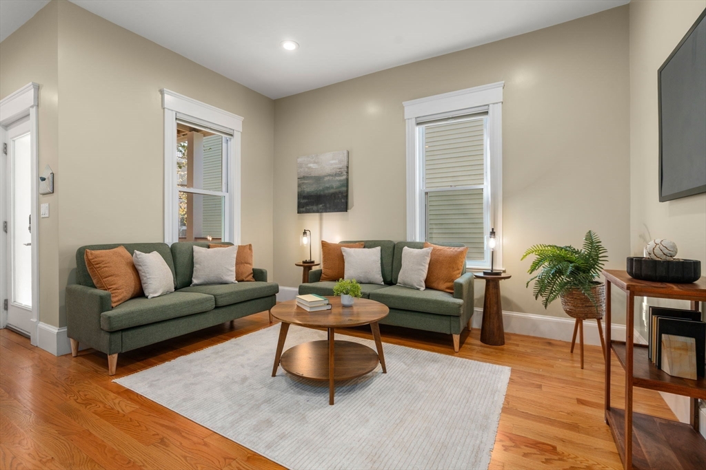 19 Pinckney Street, Unit 1 Somerville, MA 02145 - Photo 4 of 39 a living room with furniture and a wooden floor
