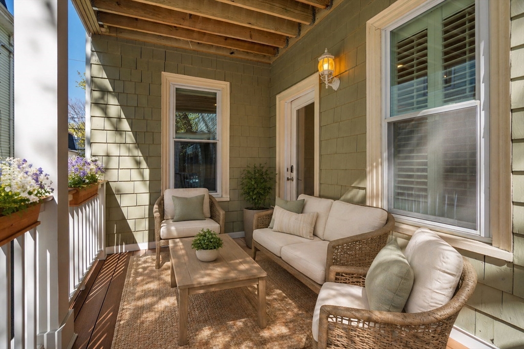19 Pinckney Street, Unit 1 Somerville, MA 02145 - Photo 7 of 39 a balcony with furniture and a potted plant