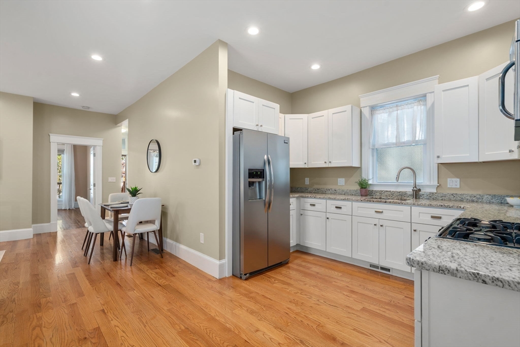 19 Pinckney Street, Unit 1 Somerville, MA 02145 - Photo 10 of 39 a kitchen with granite countertop a refrigerator stove top oven and sink