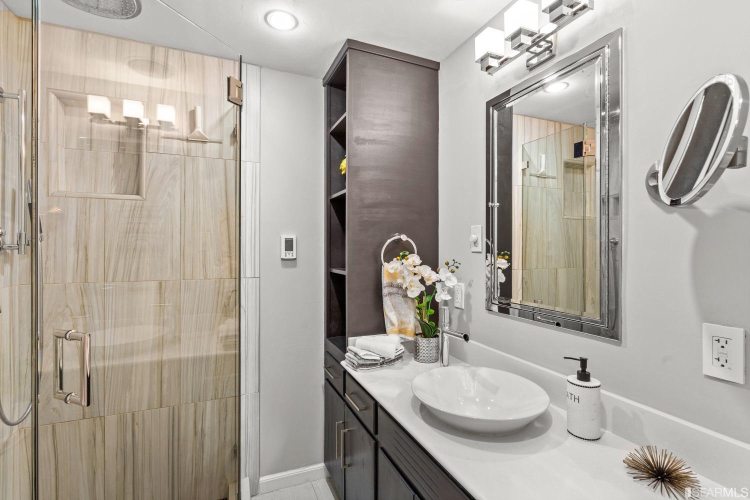 1854 Key Boulevard El Cerrito, CA 94530 - Photo 30 of 43 a bathroom with a granite countertop sink a mirror and shower