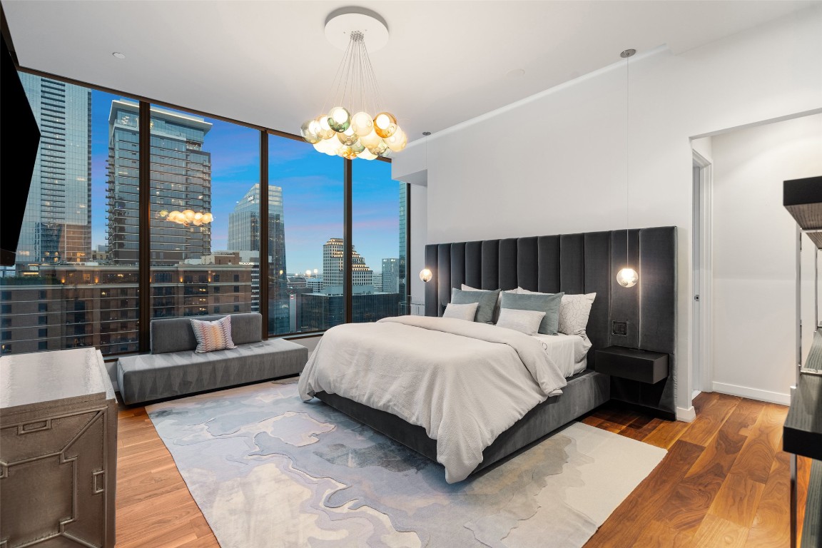210 Lavaca Street, Unit 2505 Austin, TX 78701 - Photo 26 of 40 a bedroom with a large bed and a chandelier