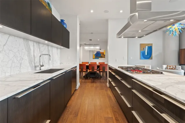 a large kitchen with stainless steel appliances a large counter top
