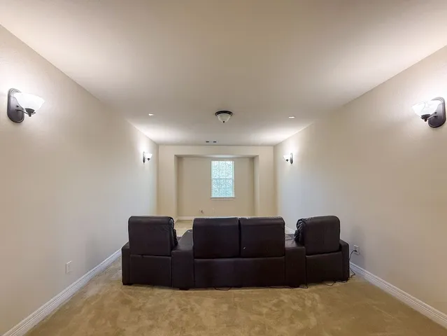 a living room with a couch and a dresser with wooden floor