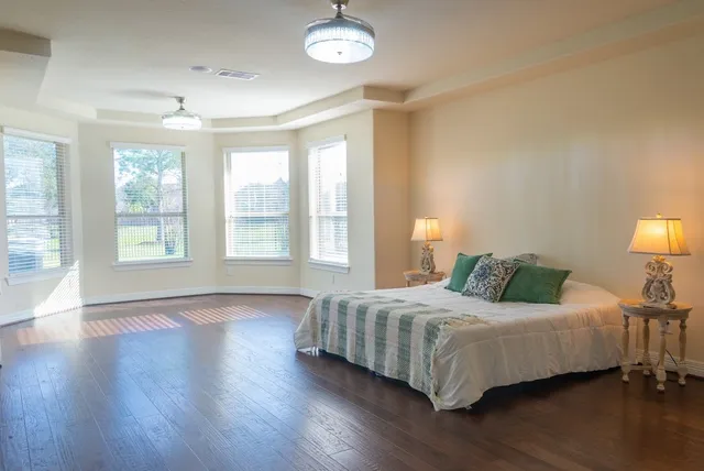 a bedroom with a bed and a large window