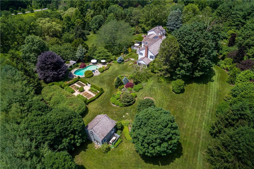 a backyard of a house with a yard and outdoor seating