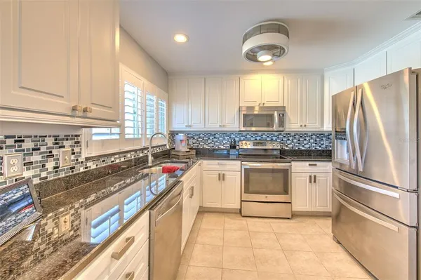 a kitchen with cabinets appliances and a sink