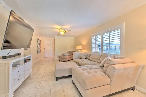 a dining room with furniture and chandelier large window