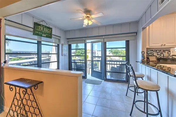 a view of a balcony with wooden floor & fence