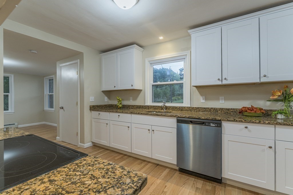 20 Laurelwood Road Rutland, MA 01543 - Photo 5 of 31 a kitchen with granite countertop a sink stove and cabinets