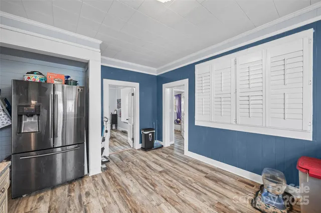 a kitchen with stainless steel appliances a refrigerator and wooden floor