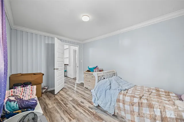 a bedroom with a bed and a chair