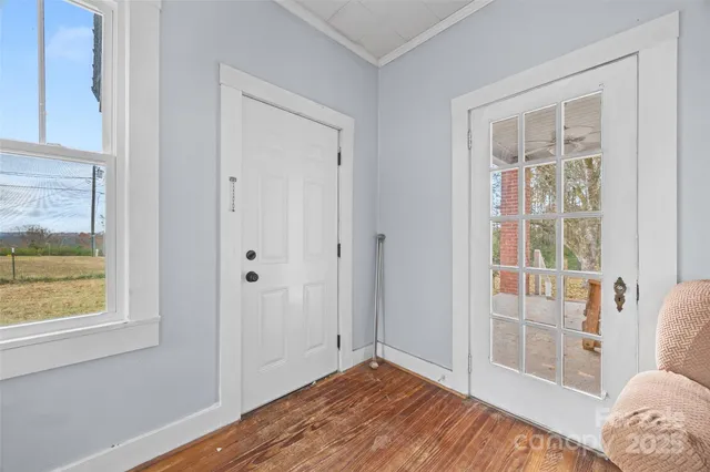 a view of room with window and wooden floor