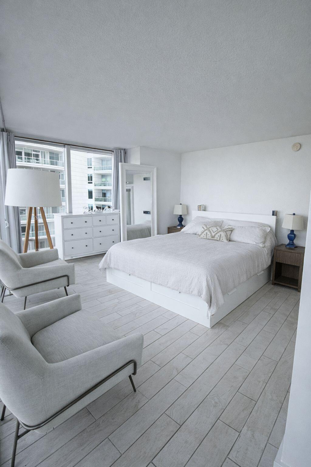 2101 Brickell Avenue, Unit 507 Miami, FL 33129 - Photo 11 of 25 a spacious bedroom with a bed and couch