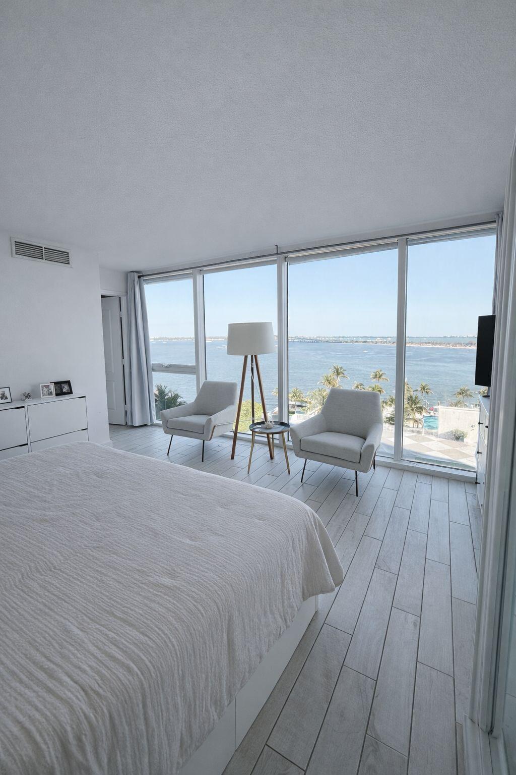 2101 Brickell Avenue, Unit 507 Miami, FL 33129 - Photo 12 of 25 a bed room with two beds and large windows
