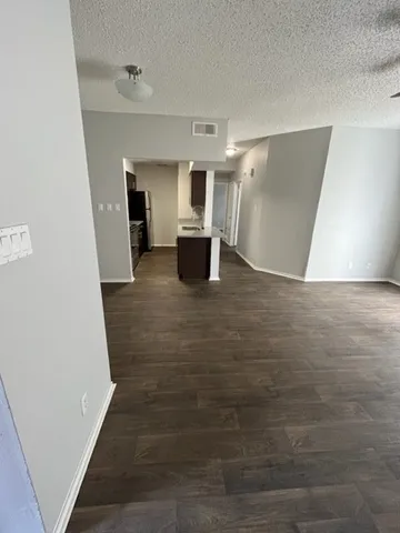 a view of a big room with wooden floor and cabinet