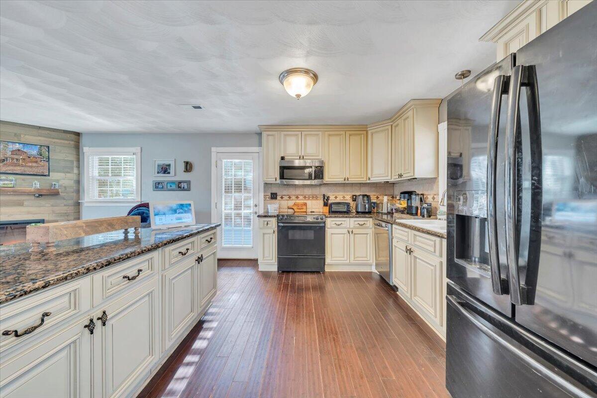 2166 Ruritan Road Roanoke, VA 24012 - Photo 14 of 46 a kitchen with granite countertop a refrigerator stove top oven and sink