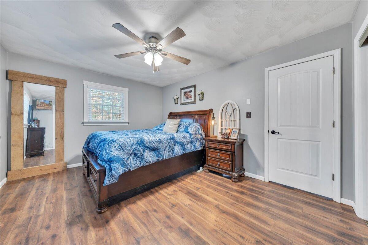 2166 Ruritan Road Roanoke, VA 24012 - Photo 17 of 46 a bedroom with a bed and wooden floor