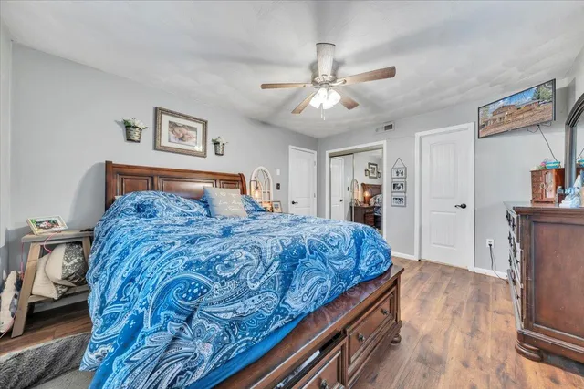 a bedroom with a large bed and a chandelier