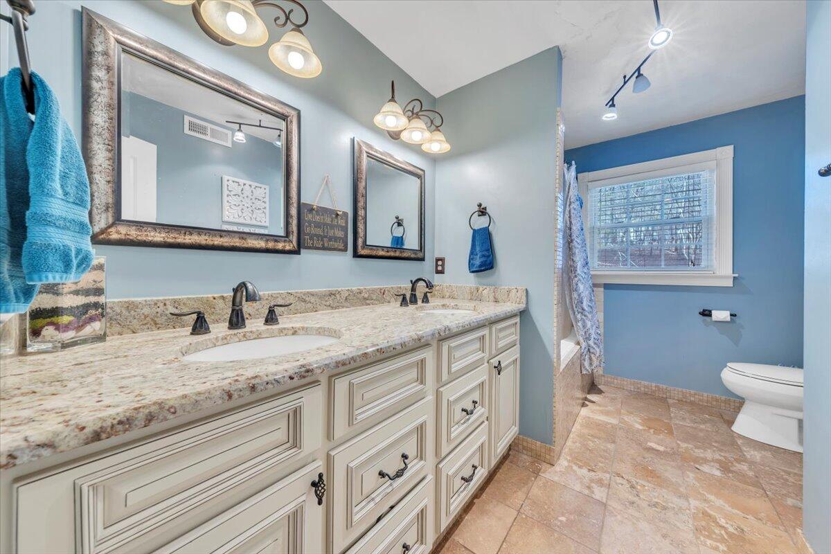 2166 Ruritan Road Roanoke, VA 24012 - Photo 20 of 46 a bathroom with a granite countertop sink mirror vanity and toilet