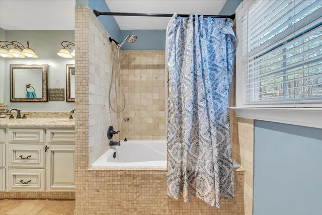 a bathroom with a bathtub and a sink