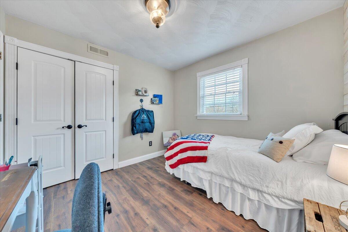 2166 Ruritan Road Roanoke, VA 24012 - Photo 23 of 46 a bedroom with a bed and a chandelier