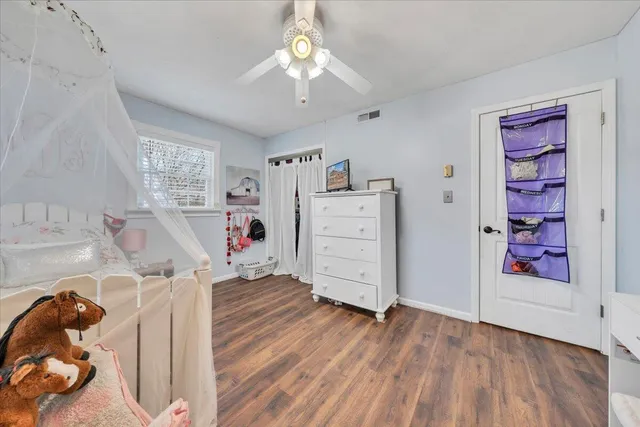 a view of a bedroom with baby crib and dresser