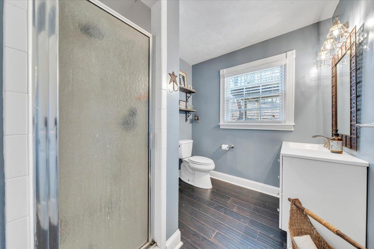 2166 Ruritan Road Roanoke, VA 24012 - Photo 33 of 46 a bathroom with a granite countertop toilet a sink and a mirror