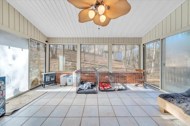 a living room with a large window and furniture