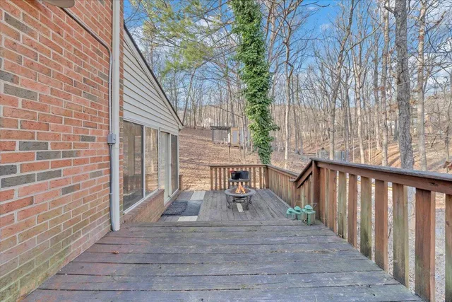 a view of a house with backyard and deck