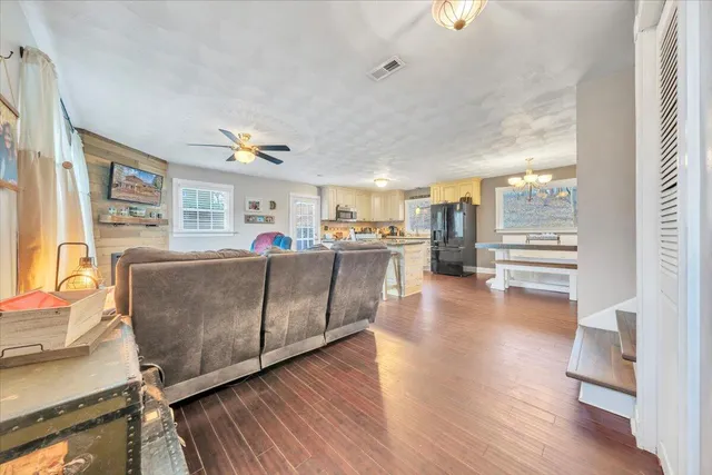 a living room with furniture and a kitchen view