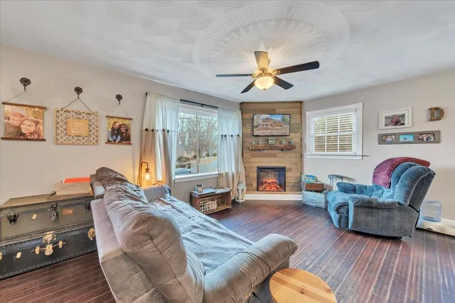 a living room with fireplace furniture and a wooden floor