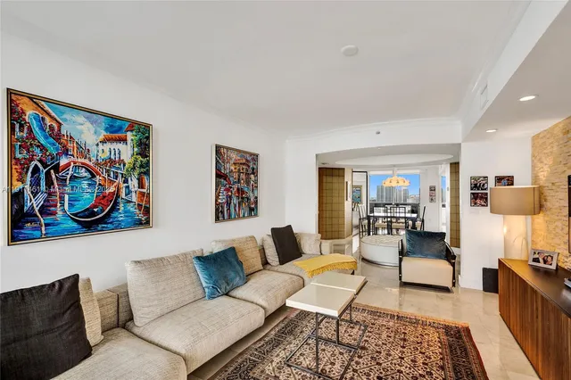 a dining room with furniture and a chandelier