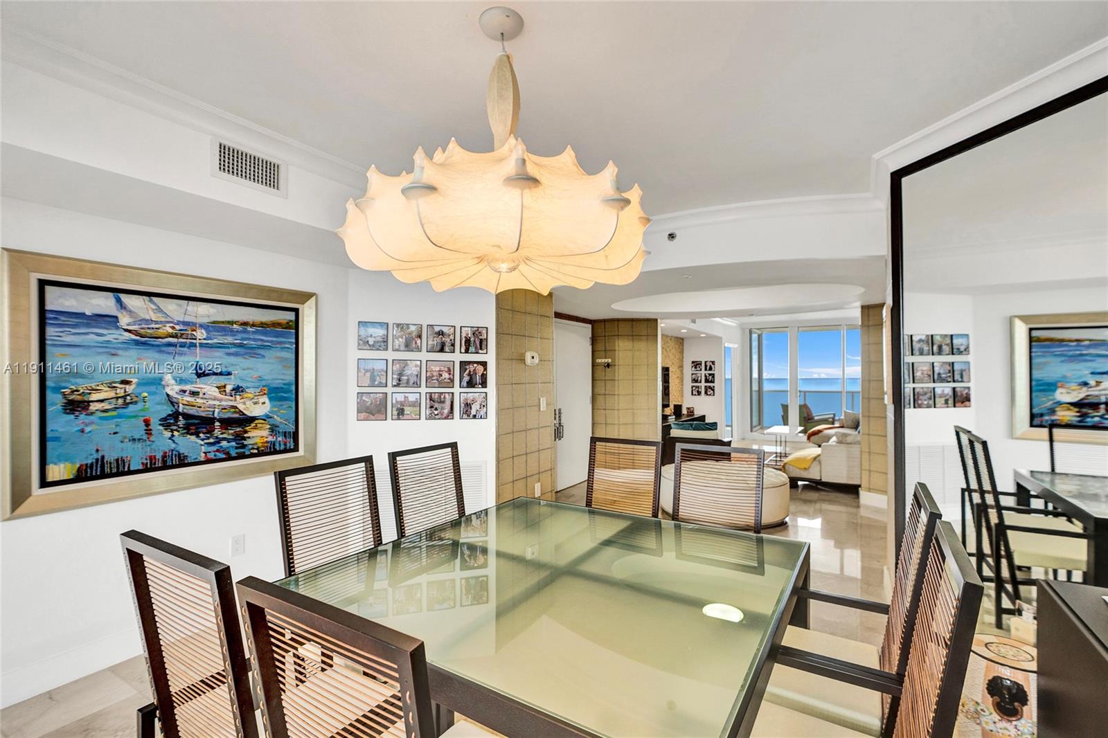 19111 Collins Avenue, Unit 1602 Sunny Isles Beach, FL 33160 - Photo 22 of 93 a view of a dining room with furniture a chandelier and wooden floor