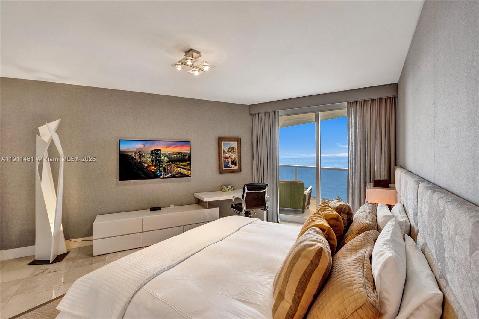 19111 Collins Avenue, Unit 1602 Sunny Isles Beach, FL 33160 - Photo 34 of 93 a bedroom with a bed and a flat screen tv