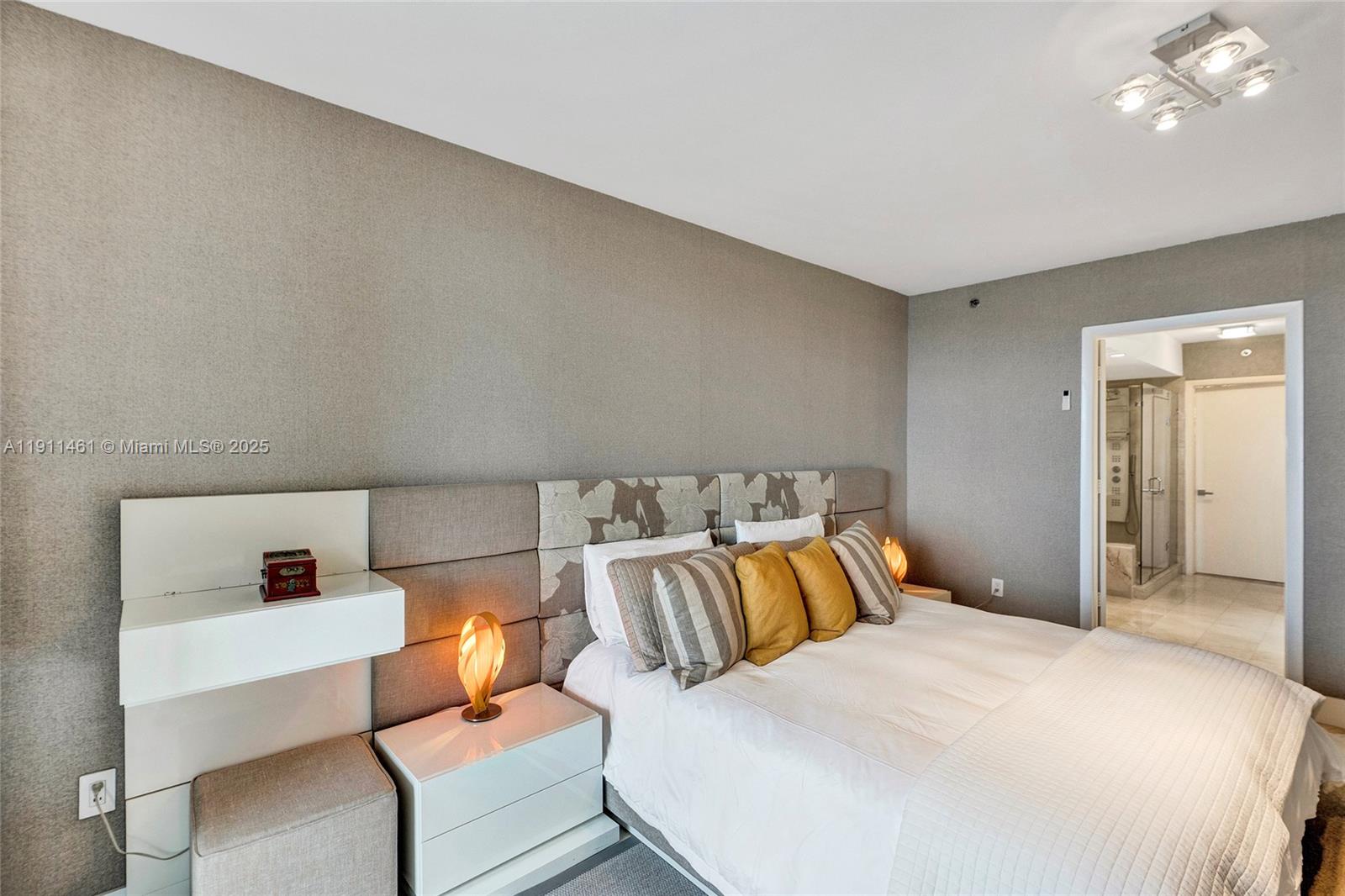 19111 Collins Avenue, Unit 1602 Sunny Isles Beach, FL 33160 - Photo 35 of 93 a bedroom with a bed and a lamp with the dresser