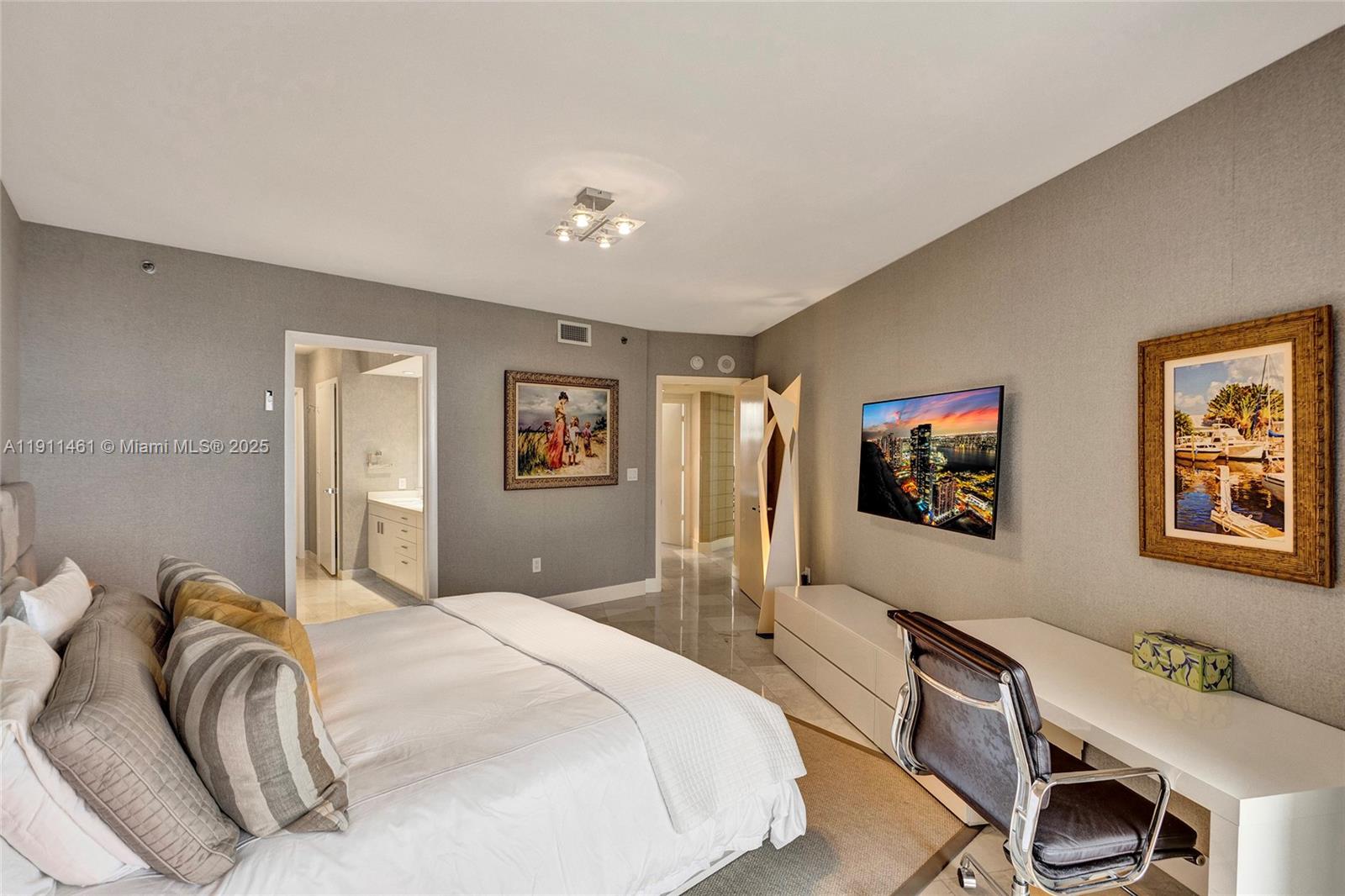 19111 Collins Avenue, Unit 1602 Sunny Isles Beach, FL 33160 - Photo 36 of 93 a bedroom with a bed and a desk