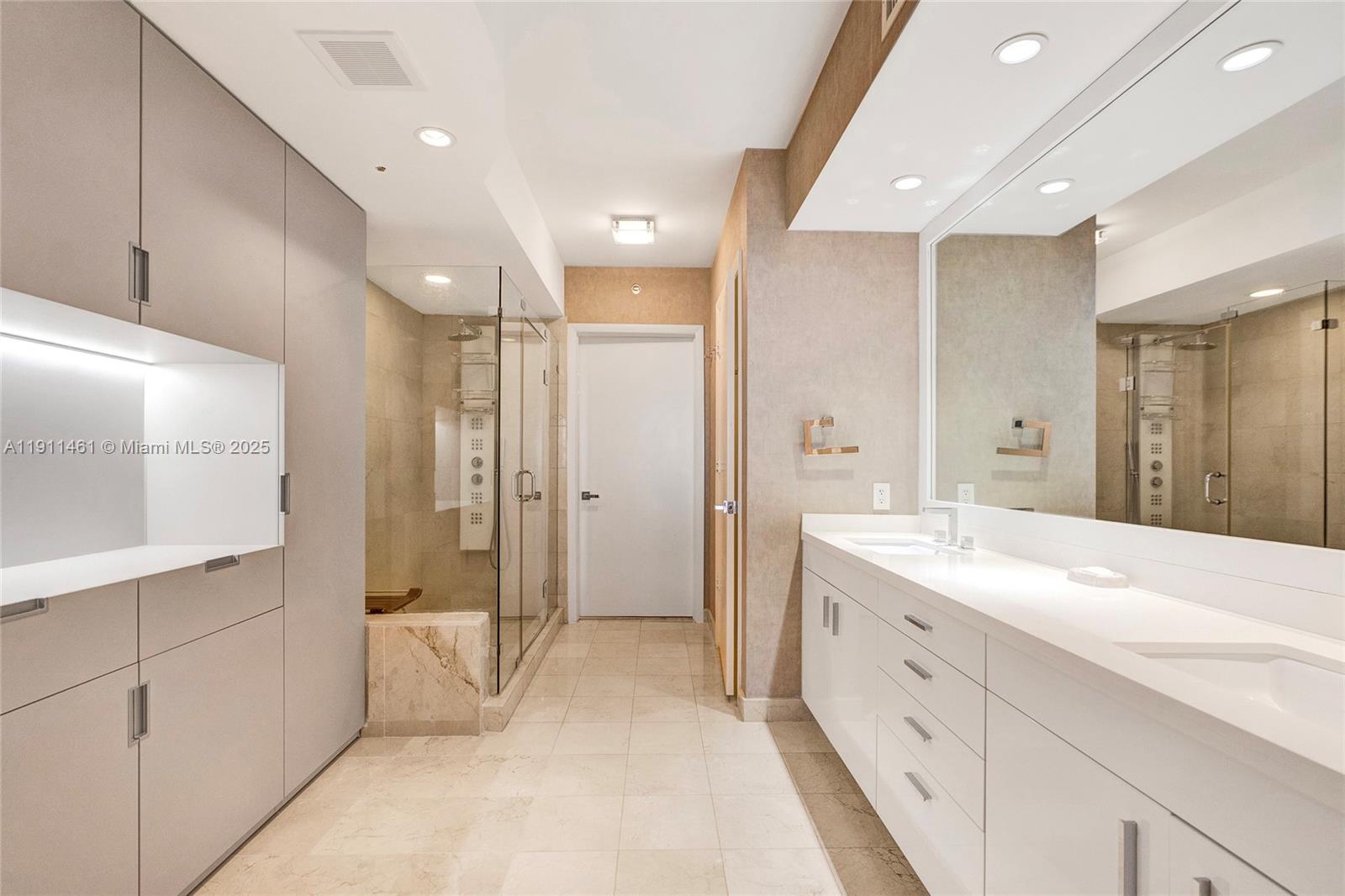 19111 Collins Avenue, Unit 1602 Sunny Isles Beach, FL 33160 - Photo 38 of 93 a spacious bathroom with a double vanity sink mirror and shower