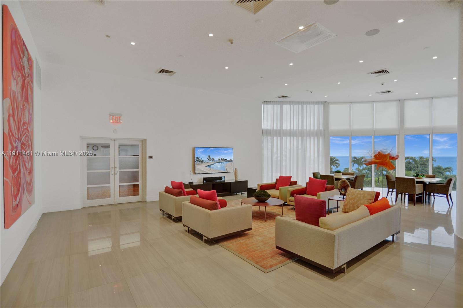 19111 Collins Avenue, Unit 1602 Sunny Isles Beach, FL 33160 - Photo 63 of 93 a living room with furniture and a flat screen tv