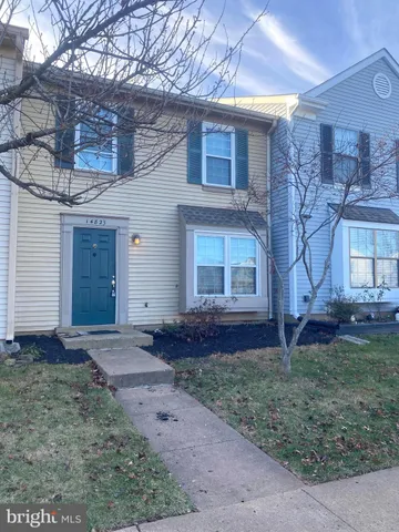 a kitchen with a refrigerator sink and cabinets