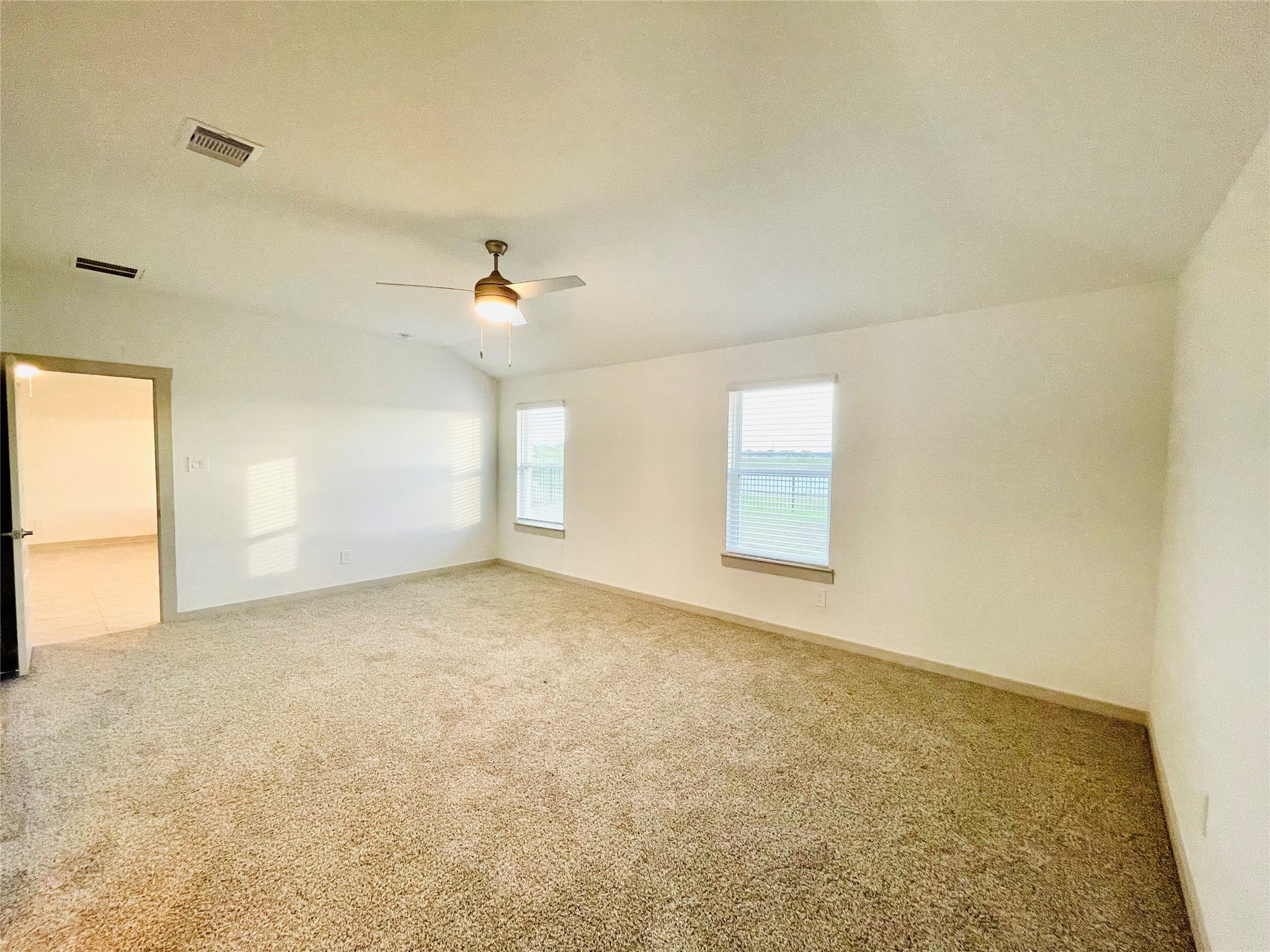28935 Yachting Point Lane Katy, TX 77494 - Photo 19 of 38 an empty room with windows and ceiling fan view
