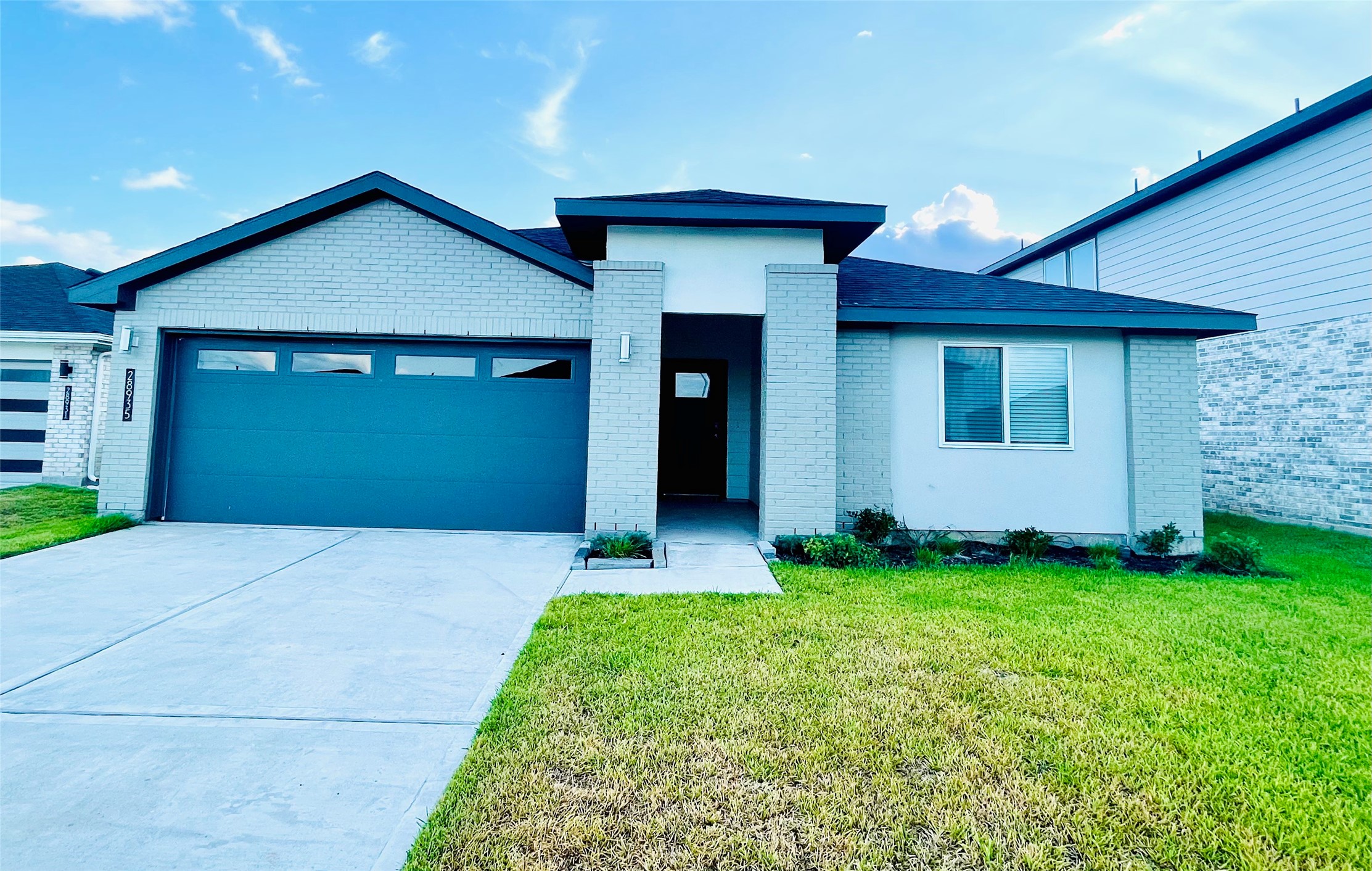 28935 Yachting Point Lane Katy, TX 77494 - Photo 2 of 38 a front view of a house with a yard and garage