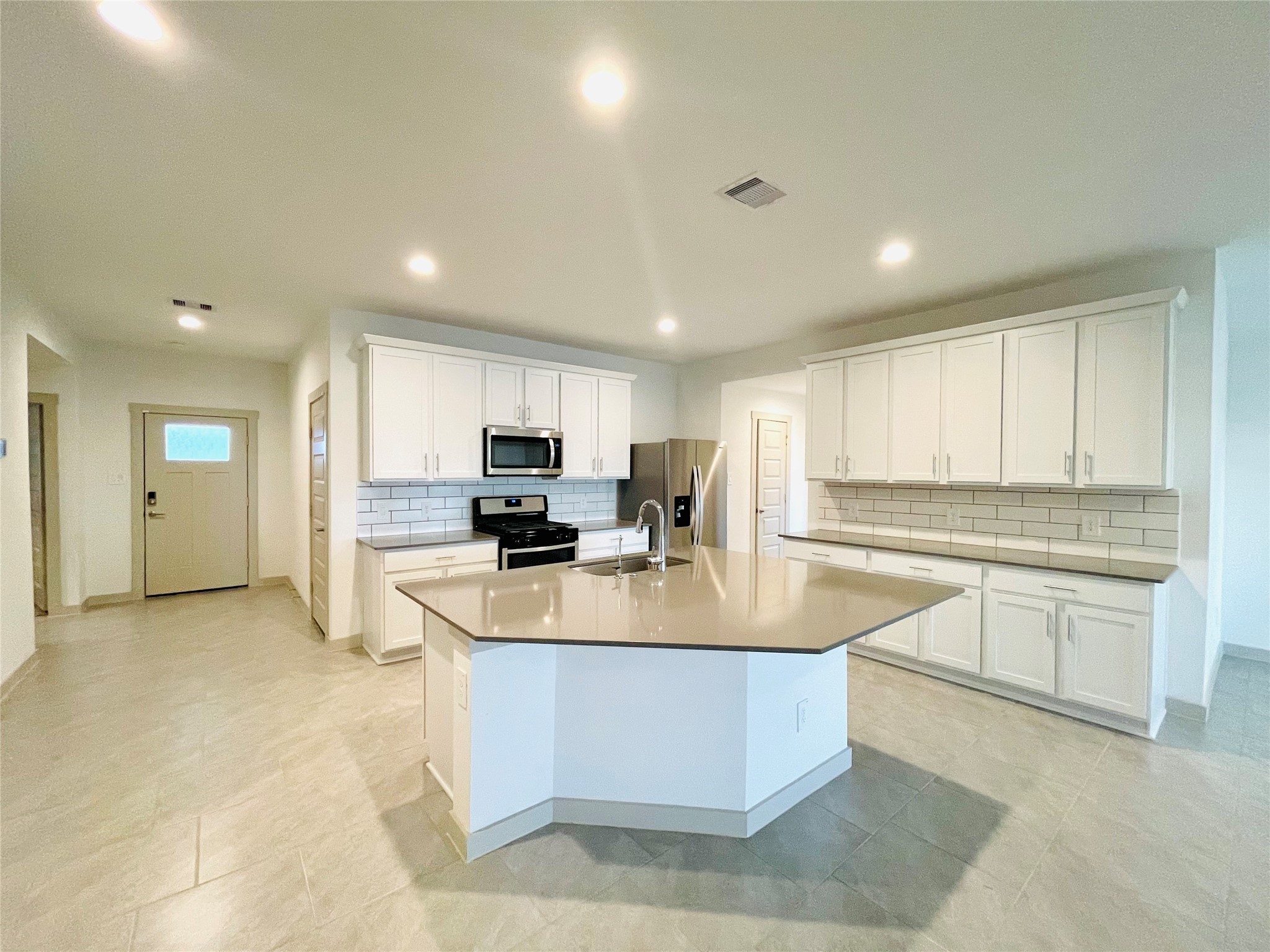 28935 Yachting Point Lane Katy, TX 77494 - Photo 6 of 38 a large kitchen with kitchen island a large counter top stainless steel appliances and cabinets